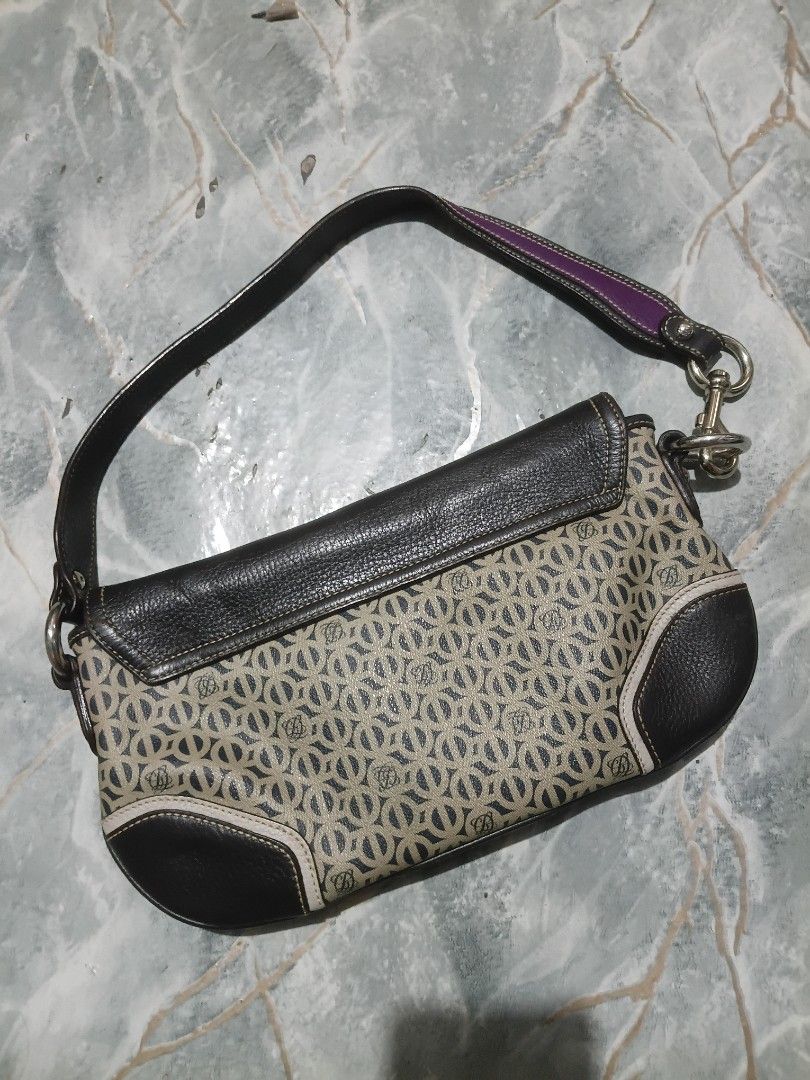 Patterned shoulder bag with purple stripe and dark brown leather (Category: Shoulder Bags) located in Cavite. Submitted by jaimebuala31560 (Listing ID 1470193404, Image 3). Description: - Eye-catching geometric patterned body - Premium dark brown leather trim - Distinct purple center stripe and matching shoulder strap accent - Secure front flap closure with magnetic snap button - Stylish silver-tone hardware links.
