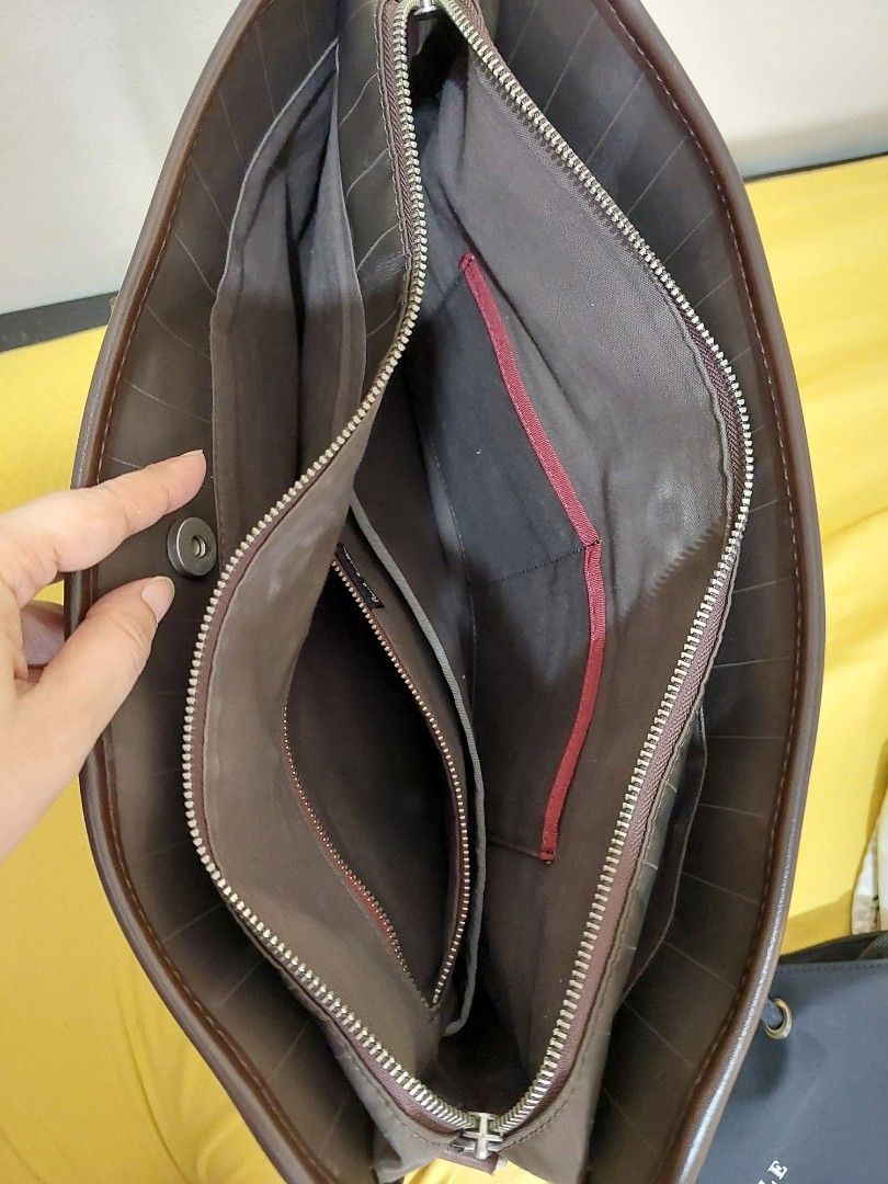 Paul Smith Brown Nylon Leather Briefcase Bag (Category: Briefcases) located in Malabon City. Submitted by jullie_bag_shop (Listing ID 1470271031, Image 3). Description: - Authentic Paul Smith briefcase in stylish brown nylon and leather - Double top handles with embossed logo patch - Secure zip exterior closure with magnetic snap top - Spacious interior lined in brown fabric with signature red trim - Includes internal zipped pocket, slip pockets,