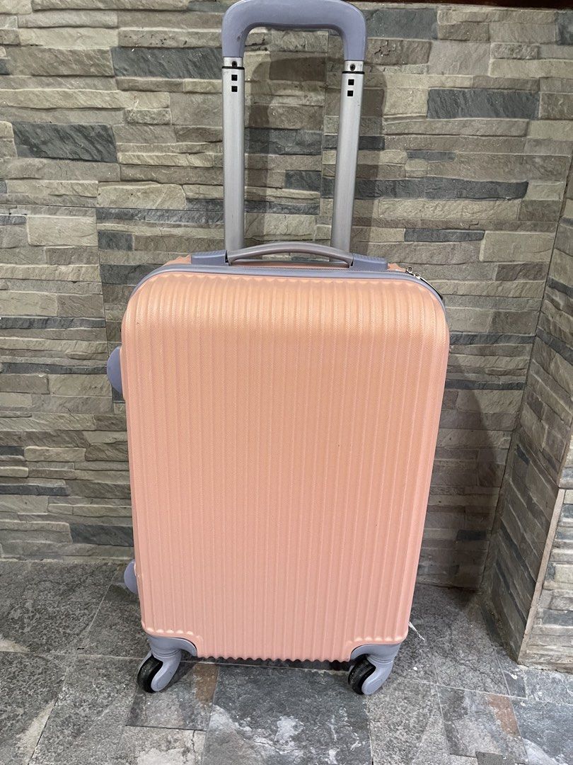 peach vertical-ribbed hard-shell rolling suitcase 21x13x9 (Category: Luggage) located in San Fernando. Submitted by japansurpluselyu (Listing ID 1470279329, Image 1). Description: .