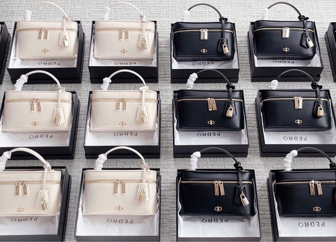 Pedro Vanity Bag Box Bag (Category: Cross-body Bags) located in Manila. Submitted by manilynpitero (Listing ID 1470143631, Image 1). Description: - Brand: Pedro - Style: Structured vanity bag with top handle - Colors available: Classic Black and White Cream - Hardware: Gold-tone with secure zipper closures and cute padlock charm details - Shape: Structured rectangular with clean, neat stitching - (great for gifting!) - Condition: Brand new, multi