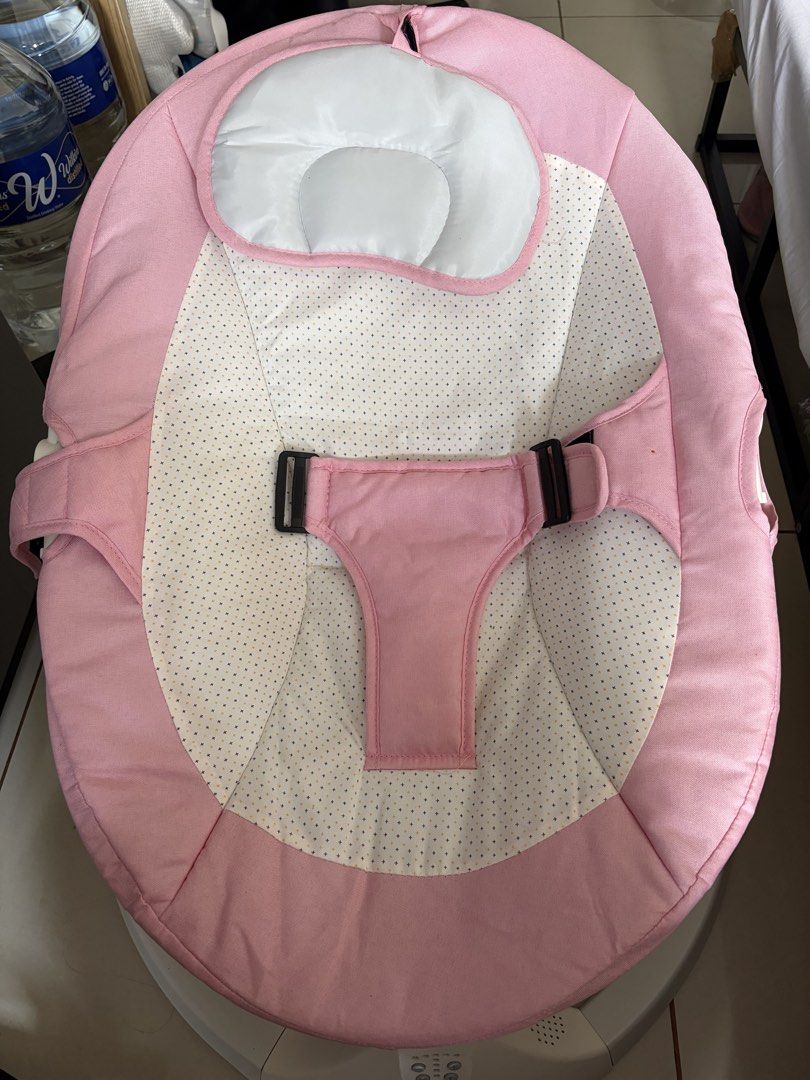 Pink Automatic Baby Rocker Electric Swing (Category: Infant Playtime) located in Quezon City. Submitted by rosenarvaez (Listing ID 1470146040, Image 2). Description: - Color: Charming pink with a white patterned center insert - Safety: Secure harness strap and sturdy curved white plastic frame - Comfort: Includes a soft, cushioned headrest and clean, ready-to-use fabric cover - Features: Built-in control panel at the base for adjustable rocking s