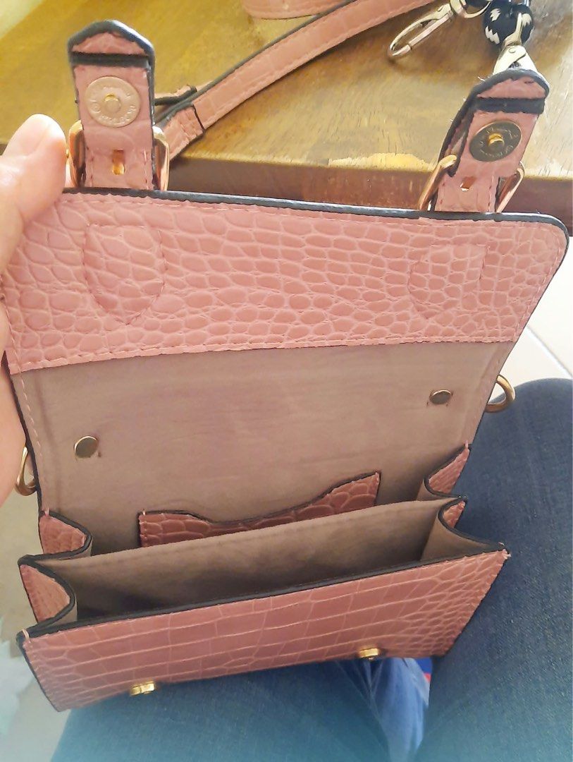 Pink Crocodile Pattern Mini Crossbody Bag with Strap (Category: Cross-body Bags) located in Manila. Submitted by djess76029 (Listing ID 1470197618, Image 3). Description: - Brand: Kurbang Lokal - Color & Texture: Pink with stylish croc texture - Hardware: Elegant gold-tone buckles and accents - Closure: Secure front flap with magnetic snap - Interior: Multiple compartments for cards and small essentials - Inclusions: Matching adjustable strap and