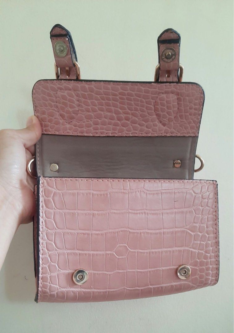 Pink Crocodile Pattern Mini Crossbody Bag with Strap (Category: Cross-body Bags) located in Manila. Submitted by djess76029 (Listing ID 1470197618, Image 2). Description: - Brand: Kurbang Lokal - Color & Texture: Pink with stylish croc texture - Hardware: Elegant gold-tone buckles and accents - Closure: Secure front flap with magnetic snap - Interior: Multiple compartments for cards and small essentials - Inclusions: Matching adjustable strap and