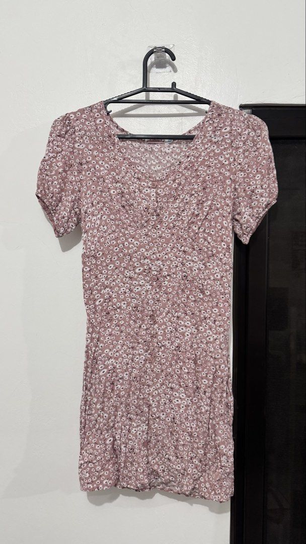 Pink floral short sleeve button-down dress (Category: Dresses) located in Muntinlupa City. Submitted by maraaalpz (Listing ID 1470274861, Image 1). Description: - Style: Pink mini dress with small white floral print - Details: V-neckline, short puff sleeves, and full front button closure - Fabric: Lightweight and breathable, ideal for sunny days - Condition: Worn a few times, freshly washed, and stored properly - Perfect for: Casual outings, date