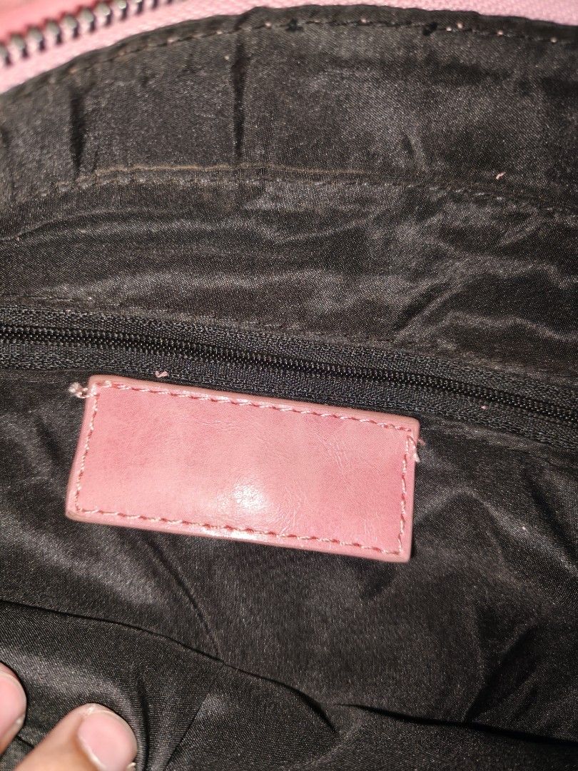 Pink motorcycle style leather handbag with mirror (Category: Luxury Bags & Wallets) located in Davao. Submitted by navil01 (Listing ID 1470313768, Image 2). Description: - Style: Classic motorcycle bag design in a vibrant bright pink leather - Straps: Double top handles and an adjustable shoulder strap with tassels - Details: Front zip pocket, edgy metal studs, buckle corners, and a matching pink framed mirror - Interior: Fabric-lined with a conv