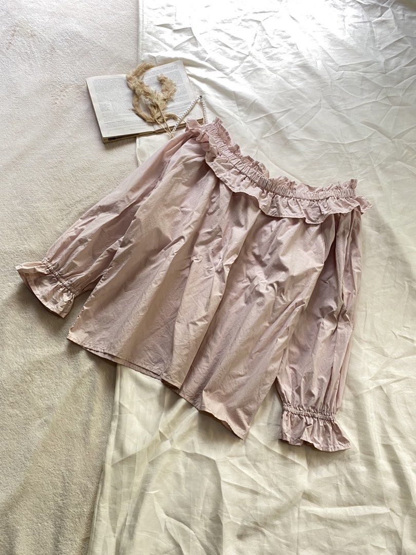 Pink Off-Shoulder Ruffle Blouse Long Sleeves Medium 38 (Category: Blouses) located in Poro. Submitted by joyceyuu (Listing ID 1470169133, Image 3). Description: - Color: Light pink - Style: Off-shoulder with cute neckline ruffles - Sleeves: Long sleeves with elasticated ruffled cuffs - Fit: Loose and comfortable - Material: Soft cotton - Best for: Casual daily wear or weekend outings.