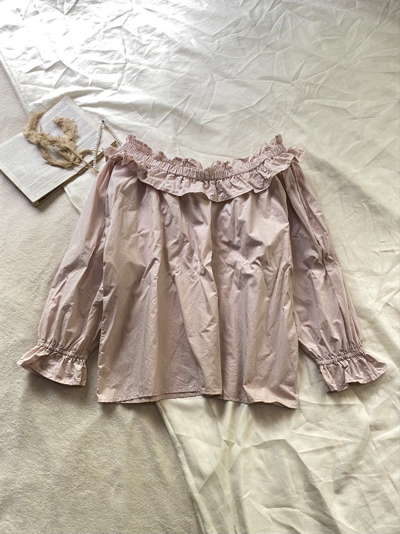 Pink Off-Shoulder Ruffle Blouse Long Sleeves Medium 38 (Category: Blouses) located in Poro. Submitted by joyceyuu (Listing ID 1470169133, Image 1). Description: - Color: Light pink - Style: Off-shoulder with cute neckline ruffles - Sleeves: Long sleeves with elasticated ruffled cuffs - Fit: Loose and comfortable - Material: Soft cotton - Best for: Casual daily wear or weekend outings.