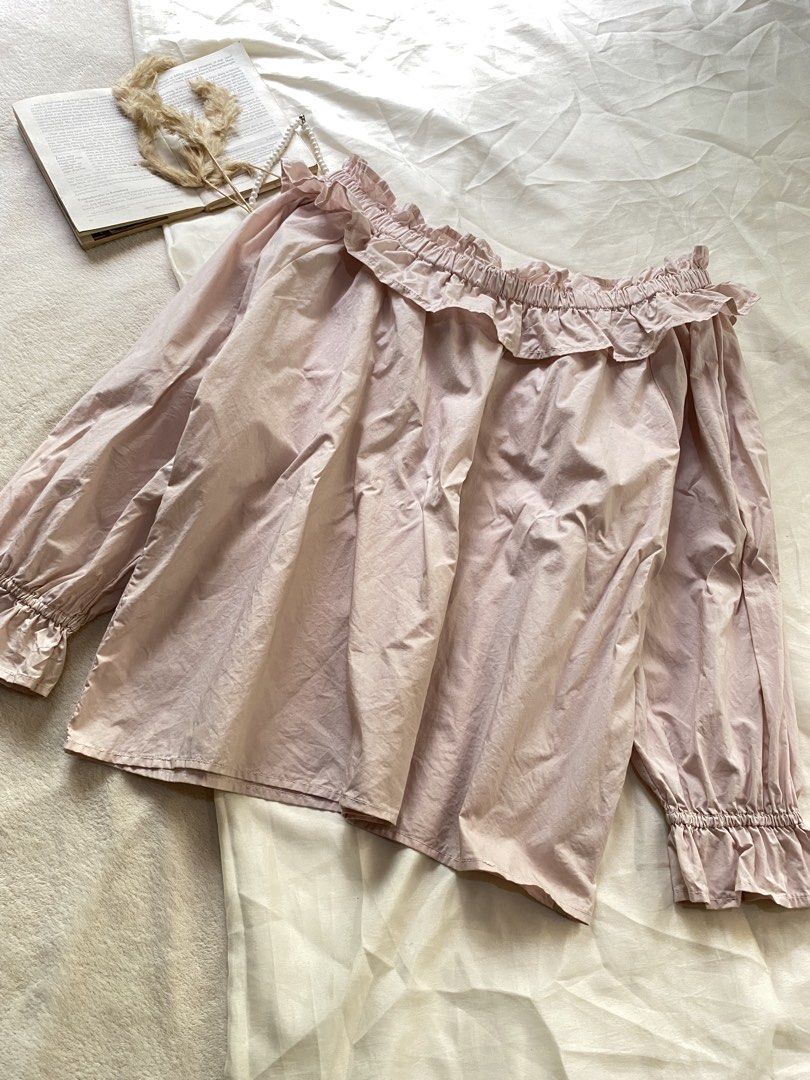 Pink Off-Shoulder Ruffle Blouse Long Sleeves Medium 38 (Category: Blouses) located in Poro. Submitted by joyceyuu (Listing ID 1470169133, Image 2). Description: - Color: Light pink - Style: Off-shoulder with cute neckline ruffles - Sleeves: Long sleeves with elasticated ruffled cuffs - Fit: Loose and comfortable - Material: Soft cotton - Best for: Casual daily wear or weekend outings.