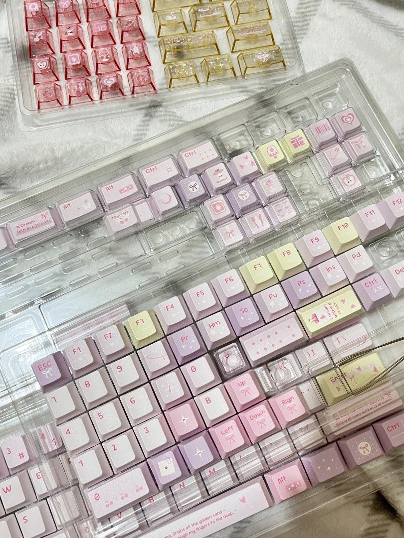 Purple/Pink keycaps (Category: Computer Keyboard) located in Bulacan. Submitted by lexareads (Listing ID 1470253490, Image 3). Description: - Full set of pink, purple, and pastel yellow keycaps - Good for all keyboard layouts (68, 75, 87, 100%) - Includes PC in pink and yellow colors - With keycap puller.