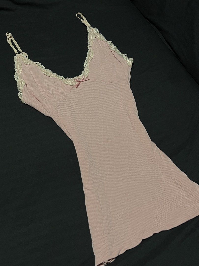 Pink Ribbed Lace Cami Top with Bow (Category: Sleeveless) located in Manila. Submitted by y2kcloset_ (Listing ID 1470182939, Image 2). Description: - Color: Soft pink - Material: Comfortable ribbed fabric with fitted silhouette - Details: White lace trim on V-neckline and cute center satin bow - Straps: Adjustable spaghetti straps - Fit: Longer hem, great for layering or wearing solo - Condition: Brand new / Excellent quality.