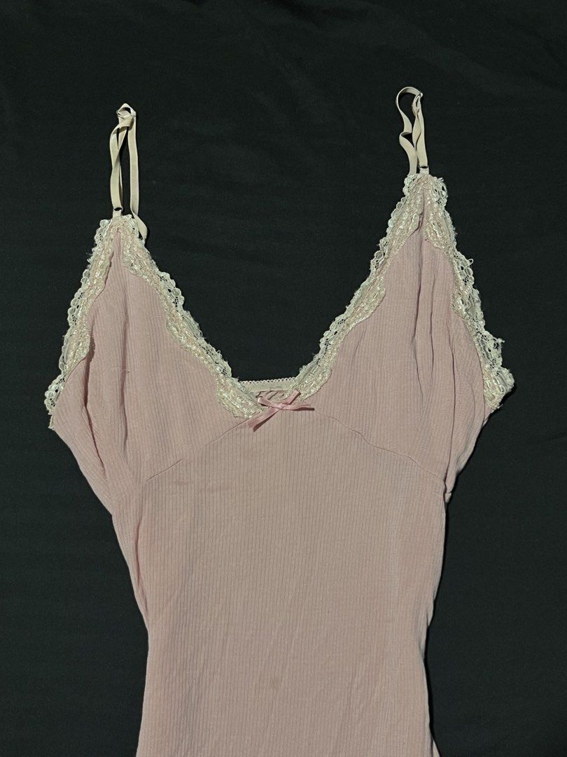 Pink Ribbed Lace Cami Top with Bow (Category: Sleeveless) located in Manila. Submitted by y2kcloset_ (Listing ID 1470182939, Image 3). Description: - Color: Soft pink - Material: Comfortable ribbed fabric with fitted silhouette - Details: White lace trim on V-neckline and cute center satin bow - Straps: Adjustable spaghetti straps - Fit: Longer hem, great for layering or wearing solo - Condition: Brand new / Excellent quality.