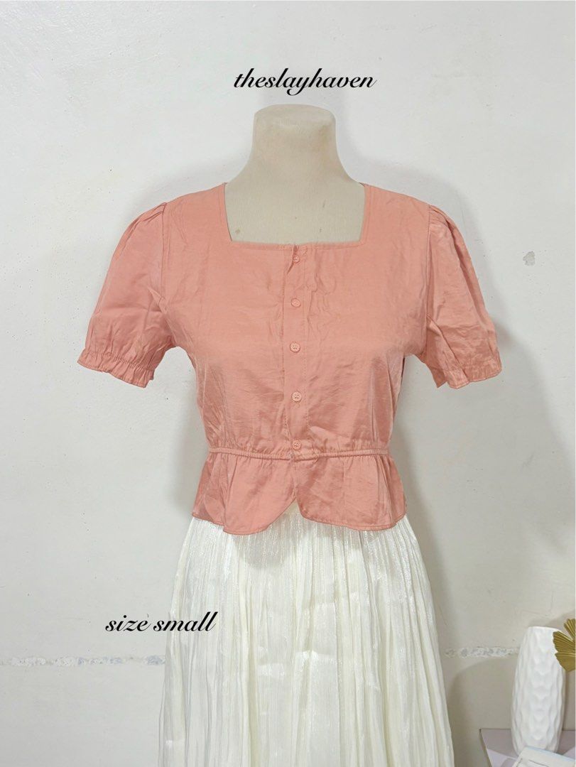 Pink Square Neck Button-Up Peplum Blouse Size Small (Category: Blouses) located in Manila. Submitted by biacakes (Listing ID 1470262274, Image 1). Description: - Color: Dusty pink - Size: Small - Design: Square neckline with 5 front buttons and gathered puff sleeves - Fit: Elastic waistband with a peplum hem - Material: Lightweight and comfortable.