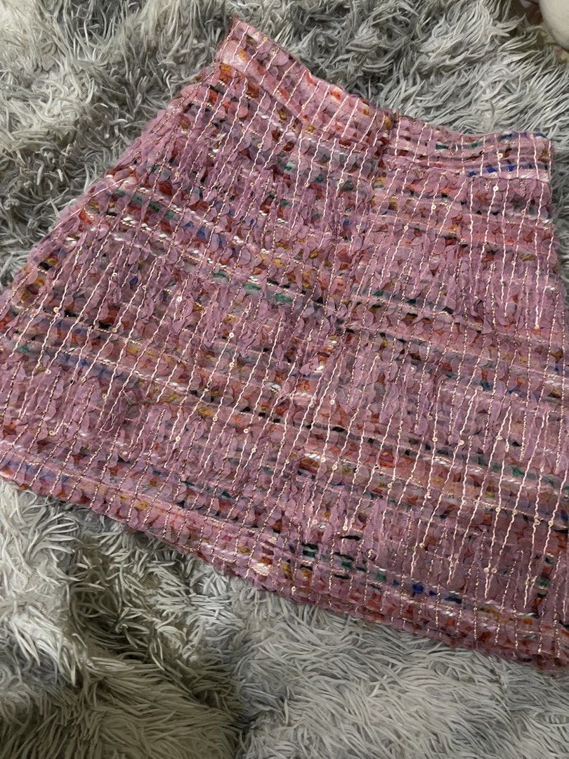 Pink textured tweed mini skirt with sequins (Category: Skirts) located in Manila. Submitted by zhahanna (Listing ID 1470227806, Image 2). Description: - Style: High-waisted mini skirt - waist: 24 in length: 10 in - Details: Pink textured fabric woven with multi-colored threads and tiny sequins - Closure: Hidden side zipper - Mode of Payment: GCash - Shipping: Via J&T Express (Buyer shoulders shipping fee) or same-day delivery via Lalamove/Grab (M