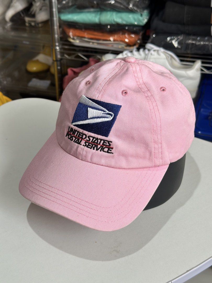 Pink USPS United States Postal Service Cap (Category: Caps & Hats) located in Daet. Submitted by thrifthings2018 (Listing ID 1470193781, Image 2). Description: - Brand: Cap America - Design: Pink baseball cap with embroidered USPS logo - Fit: Adjustable back strap with brass buckle hardware - Condition: Clean fabric throughout, ready to wear - Origin: Made in China.