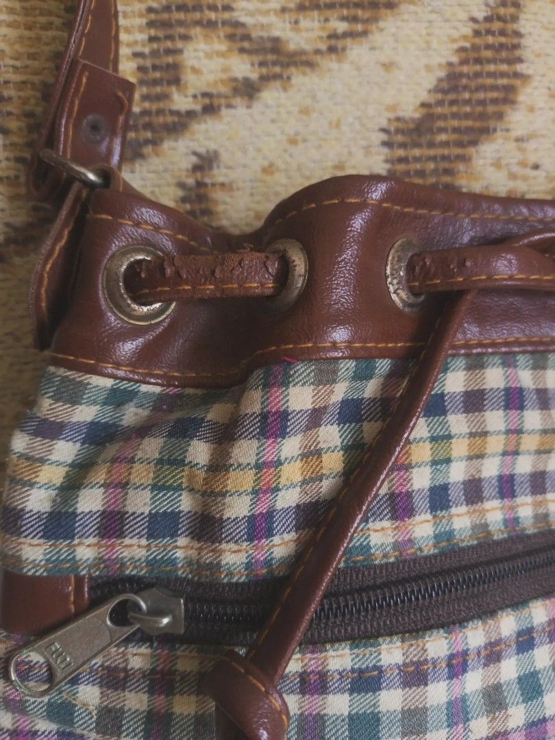 plaid bucket bag (Category: Shoulder Bags) located in San Pedro. Submitted by vishavriksha (Listing ID 1470197296, Image 3). Description: ‎༝ size : 10" x 9" ‎༝ brand : Brice d'Alban Paris (vintage brand) ‎༝ flaws : peeling/cracking on the top brown trim around the drawstring area, plus a small dark spot on fabric near the logo badge. the interior is very clean with no damage !.