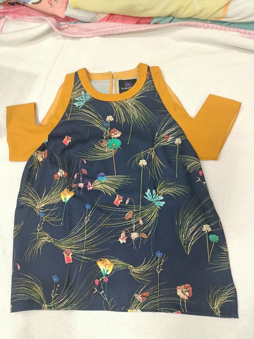 Plains & Prints Floral Cold Shoulder Blouse Size M (Category: Blouses) located in Manila. Submitted by jollynest24 (Listing ID 1470280423, Image 1). Description: - Brand: Plains & Prints - Design: Colorful botanical print on dark navy fabric with mustard yellow trim - Details: Cold shoulder sleeves, back neck button closure - Size: PHL M, EUR 10, USA 6 - Fabric: Lightweight and comfortable - Styling: Great for pairing with jeans or skirts - Condi