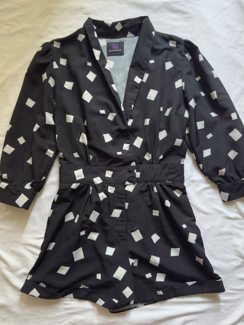 Plains&Prints black and white patterned romper playsuit Small (Category: Rompers) located in Cebu City. Submitted by _t.rix (Listing ID 1470187972, Image 3). Description: - Color & Print: Black with white square abstract print - Design: V-neck collar, 3/4 sleeves with button cuffs, and rolled cuff shorts - Waist: Fitted waistband with front button closure - Fabric: Lightweight, comfortable, and easy to style - Occasion: Perfect for casual daytime