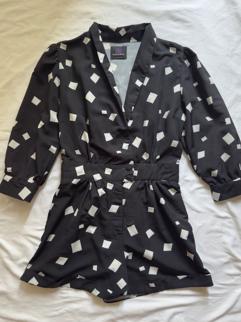Plains&Prints black and white patterned romper playsuit Small (Category: Rompers) located in Cebu City. Submitted by _t.rix (Listing ID 1470187972, Image 2). Description: - Color & Print: Black with white square abstract print - Design: V-neck collar, 3/4 sleeves with button cuffs, and rolled cuff shorts - Waist: Fitted waistband with front button closure - Fabric: Lightweight, comfortable, and easy to style - Occasion: Perfect for casual daytime