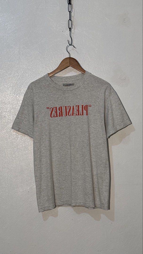 Pleasures Grey T-Shirt Medium (Category: Tshirts & Polo Shirts ) located in Manila. Submitted by glano (Listing ID 1470299360, Image 1). Description: - Brand: Pleasures - Color: Heather Grey - Design: Red inverted text graphic on chest - Size: Medium (Made in Mexico, Printed in USA) - Material: 100% Cotton - Fit: Standard short sleeve crewneck - Condition: Excellent / Well-maintained.