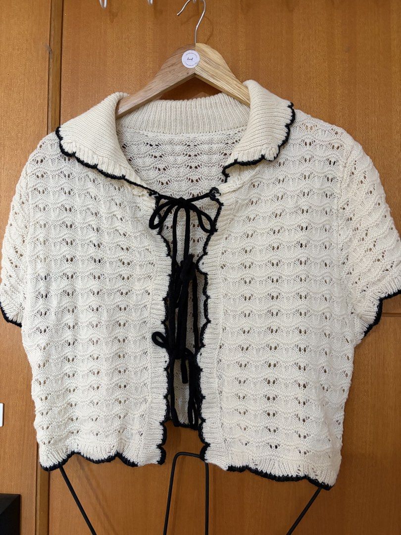 Plus size crochet cover up/blouse (Category: Blouses) located in Taguig. Submitted by jgbrl_03 (Listing ID 1470212646, Image 1). Description: - Color: Cream with black scalloped trim - Style: Short-sleeve cropped cardigan with multiple front bow ties - Fabric: Light and textured with an all-over pattern - Fit: Cropped length, pairs easily with high-waisted bottoms - Size on tag: 0xl - Worn twice.