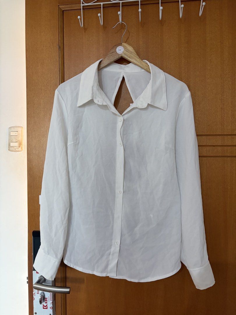 Plus size White long sleeve button down shirt with lace-up back (Category: Longsleeves) located in Taguig. Submitted by jgbrl_03 (Listing ID 1470216834, Image 1). Description: - Color: White - Style: Smart-casual / Office to night out - Design: Classic front collar with button-up closure and standard button cuffs - Special Feature: Trendy open-back with adjustable crisscross lace-up ribbon ties - Fabric: Lightweight and comfortable - Condition: w