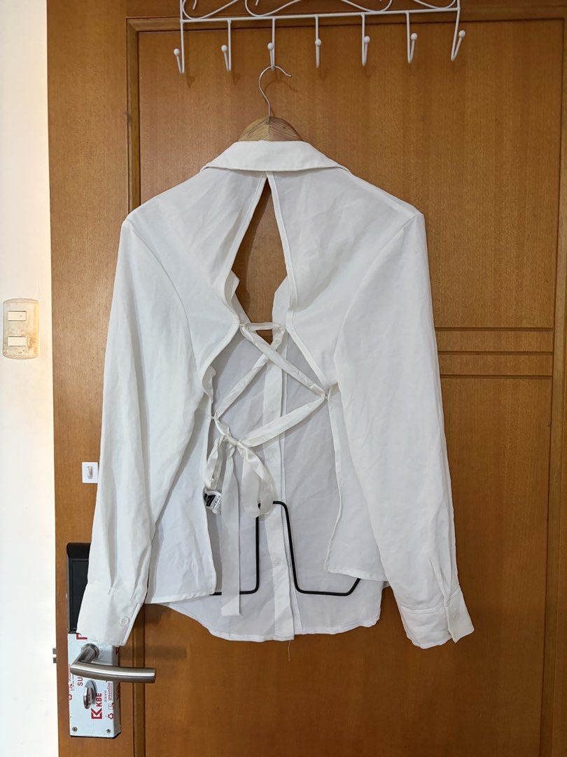Plus size White long sleeve button down shirt with lace-up back (Category: Longsleeves) located in Taguig. Submitted by jgbrl_03 (Listing ID 1470216834, Image 3). Description: - Color: White - Style: Smart-casual / Office to night out - Design: Classic front collar with button-up closure and standard button cuffs - Special Feature: Trendy open-back with adjustable crisscross lace-up ribbon ties - Fabric: Lightweight and comfortable - Condition: w