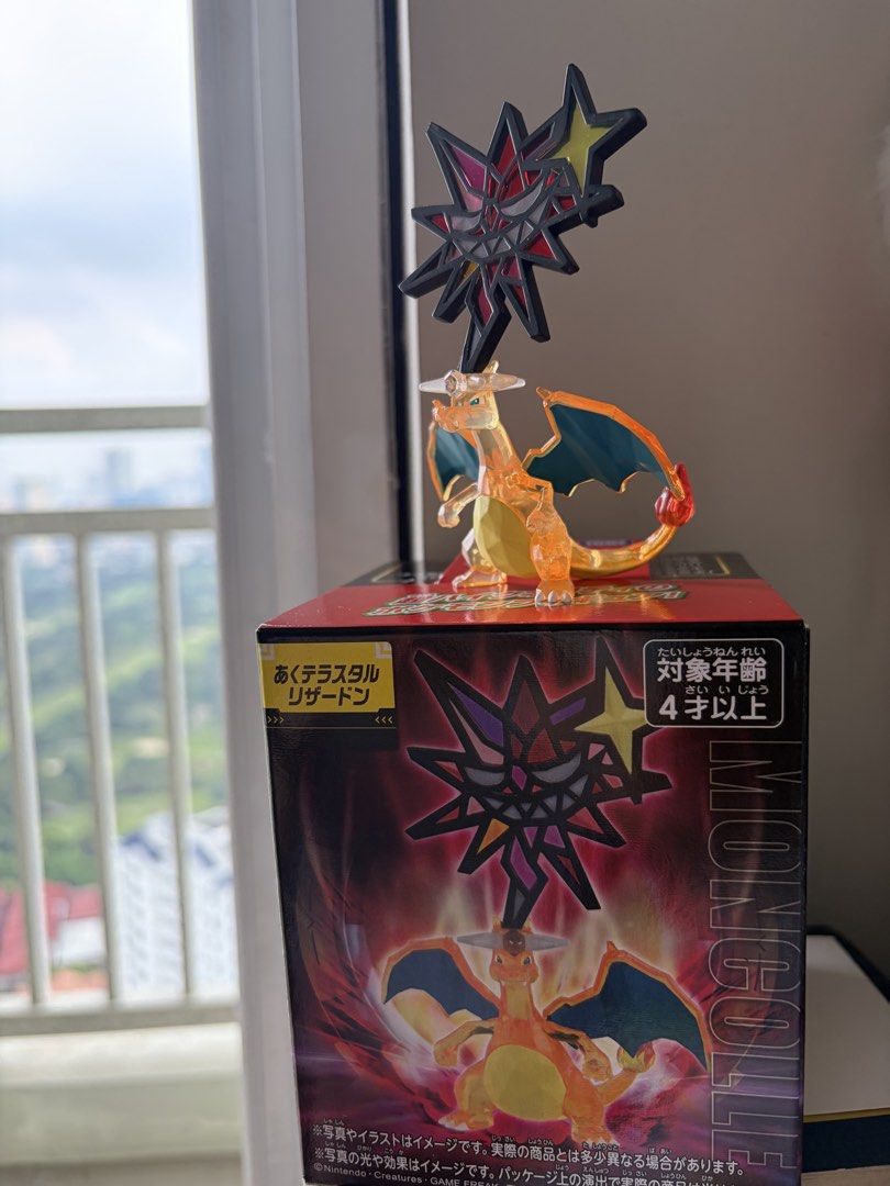 Pokemon Moncolle Dark Tera Charizard Figure with Box (Category: Figurines & Statues) located in Manila. Submitted by treasurepile (Listing ID 1470221305, Image 1). Description: - Authentic Pokémon merchandise straight from Japan - Features Charizard with a rare Dark Stellar Terastal crystal crown - Stunning transparent orange body with striking dark blue wings - Moncolle figure series collectible - Original box included in the listing - Perfect a