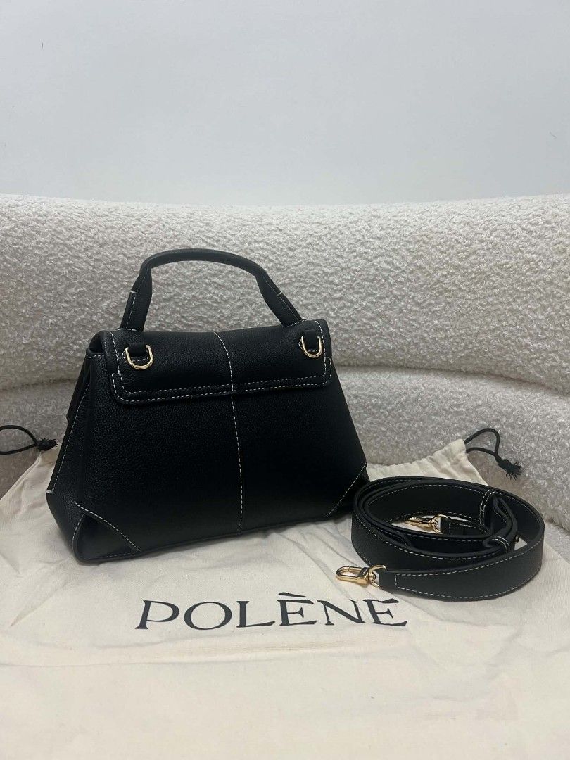 Polène Mini Mokki Black (Category: Luxury Bags & Wallets) located in Paoay. Submitted by rvf1230 (Listing ID 1470151732, Image 3). Description: - Brand: Polène Mini Mokki - Color: Black grained leather with contrast white stitching - Design: Curved panels, structured shape, and top handle - Strap: Detachable matching shoulder strap with gold hardware - Base: Four protective metal feet - Inclusions: Dustbag - Condition: Excellent/Pristine.