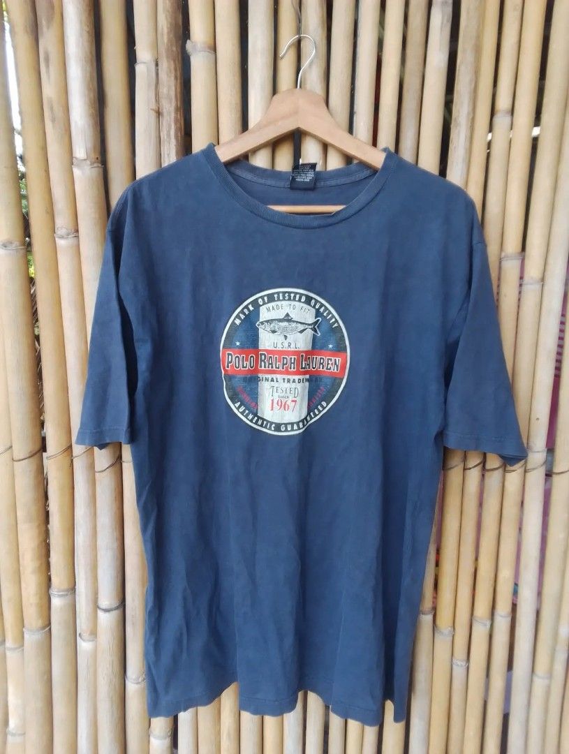 Polo by RALPH LAUREN (Category: Tshirts & Polo Shirts ) located in Palayan City. Submitted by angelicapelagiobuates-blueapp (Listing ID 1470348920, Image 1). Description: Polo Ralph Lauren Vintage Tee- Navy Blue Size XL details: Authentic Polo by RALPH LAUREN 100% cotton size xl made in colombia color faded navy/vintage wash PRINT: Mark of tested quality tested since 1967/ fish graphic condition 9/10 DIMES: 21/28.5 no major issues.
