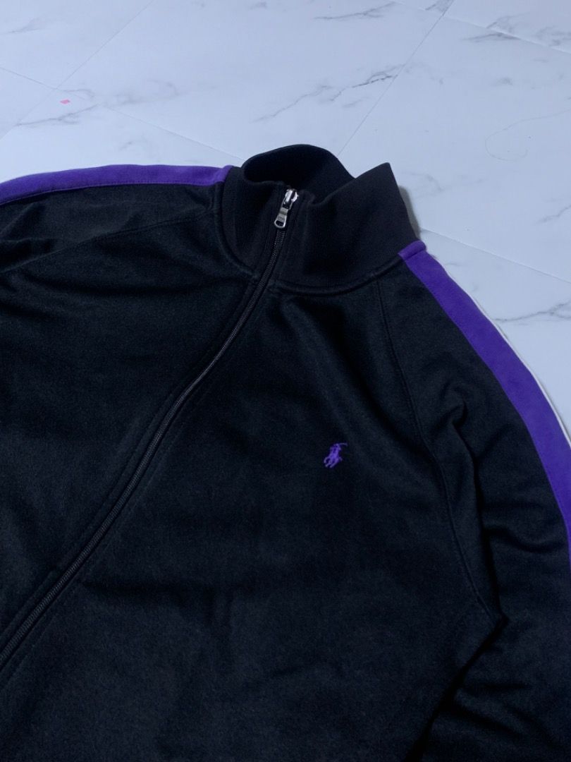Polo by Ralph Lauren Track Jacket (Category: Coats, Jackets and Outerwear) located in Tarlac. Submitted by thriftniaki (Listing ID 1470327729, Image 2). Description: - Brand: Polo by Ralph Lauren - Item: Black track jacket - Size: Medium - Details: Purple stripes on sleeves, purple embroidered pony logo on chest - Features: Full zip front, stand-up collar, ribbed cuffs and hem - Condition: Good pre-loved condition.