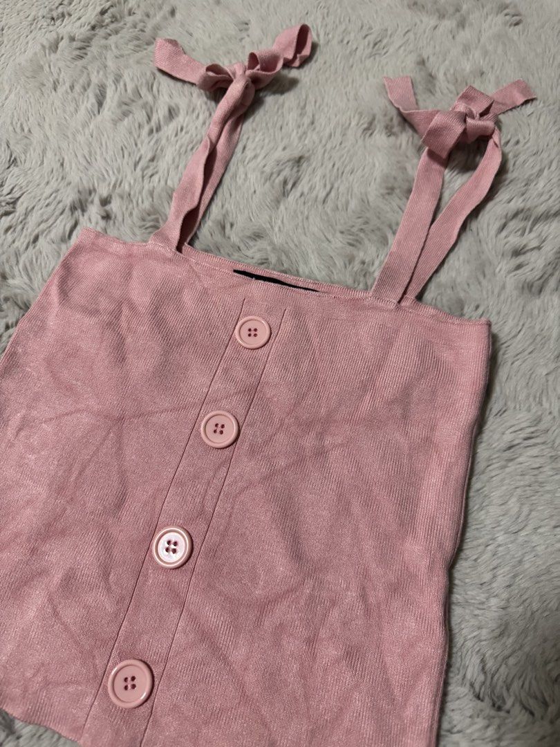 Pomelo Pink Knitted Camisole Top Size M (Category: Sleeveless) located in Calamba. Submitted by cheriiv (Listing ID 1470313617, Image 2). Description: - Brand: Pomelo - Color: Pink - Size: Medium - Material: Soft, lightweight knit with ribbed texture - Design: Self-tie ribbon shoulder straps, straight neckline, and front button placket with four matching buttons - Styling: Perfect to pair with high-waisted denim or skirts.