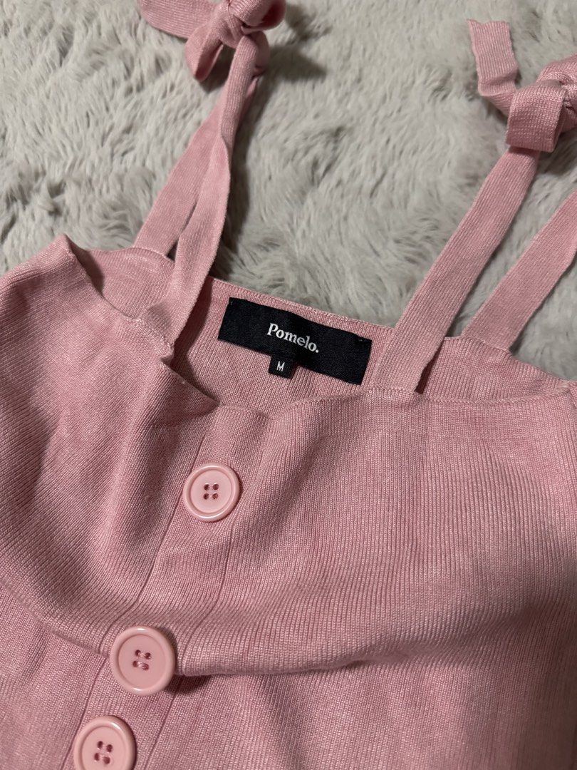 Pomelo Pink Knitted Camisole Top Size M (Category: Sleeveless) located in Calamba. Submitted by cheriiv (Listing ID 1470313617, Image 3). Description: - Brand: Pomelo - Color: Pink - Size: Medium - Material: Soft, lightweight knit with ribbed texture - Design: Self-tie ribbon shoulder straps, straight neckline, and front button placket with four matching buttons - Styling: Perfect to pair with high-waisted denim or skirts.