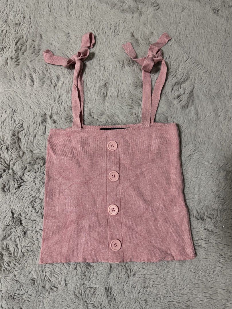 Pomelo Pink Knitted Camisole Top Size M (Category: Sleeveless) located in Calamba. Submitted by cheriiv (Listing ID 1470313617, Image 1). Description: - Brand: Pomelo - Color: Pink - Size: Medium - Material: Soft, lightweight knit with ribbed texture - Design: Self-tie ribbon shoulder straps, straight neckline, and front button placket with four matching buttons - Styling: Perfect to pair with high-waisted denim or skirts.