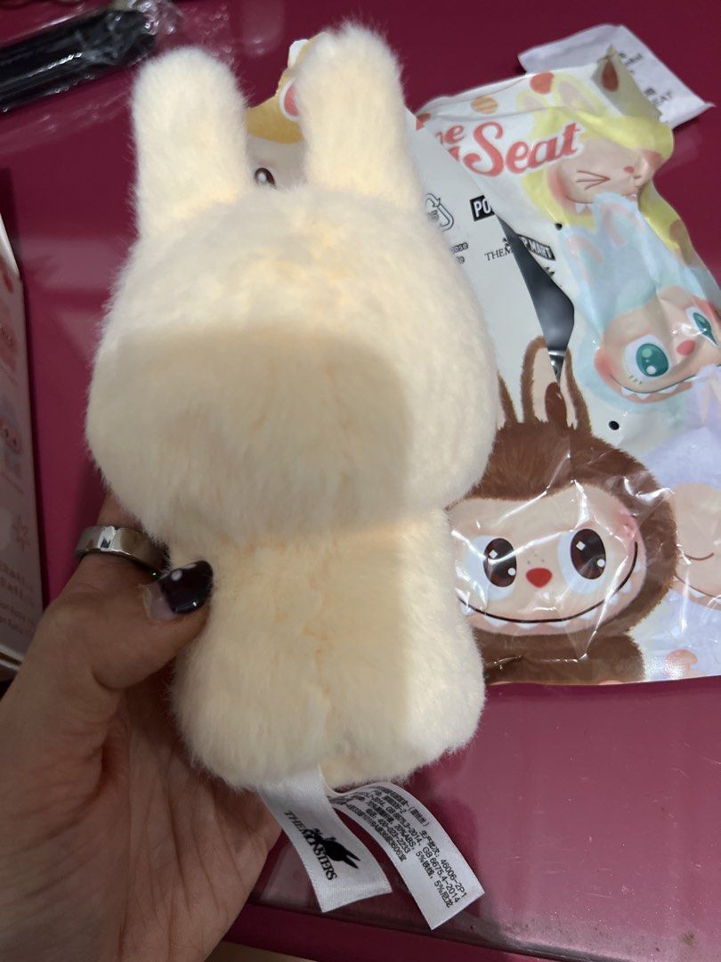 POP MART Labubu Have a Seat Plush (Category: Plushies & Soft Toys) located in Bulacan. Submitted by __randomthings (Listing ID 1470214534, Image 3). Description: - Authentic Labubu Have a Seat vinyl plush blind box figure - Color: Light yellow with fuzzy body, pointed ears, and signature sharp teeth - Condition: Box opened only to verify character, stored carefully - Inclusions: Complete with original foil packaging, character card, silica gel pa