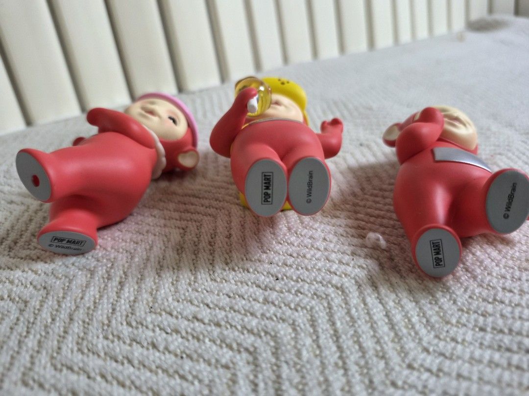POP MART Teletubbies Figurine Set (Category: Designer & Blind Box Toys) located in Manila. Submitted by boldbear2001 (Listing ID 1470298372, Image 3). Description: Three POP MART Teletubbies figures in red. Includes Po variant with pink hat, Po variant with yellow hat and yellow backpack holding candy, and standard Po figure. Authentic stamping on the bottom of the feet. Clean paint details. Great additions for a collection or display setup. -Mis