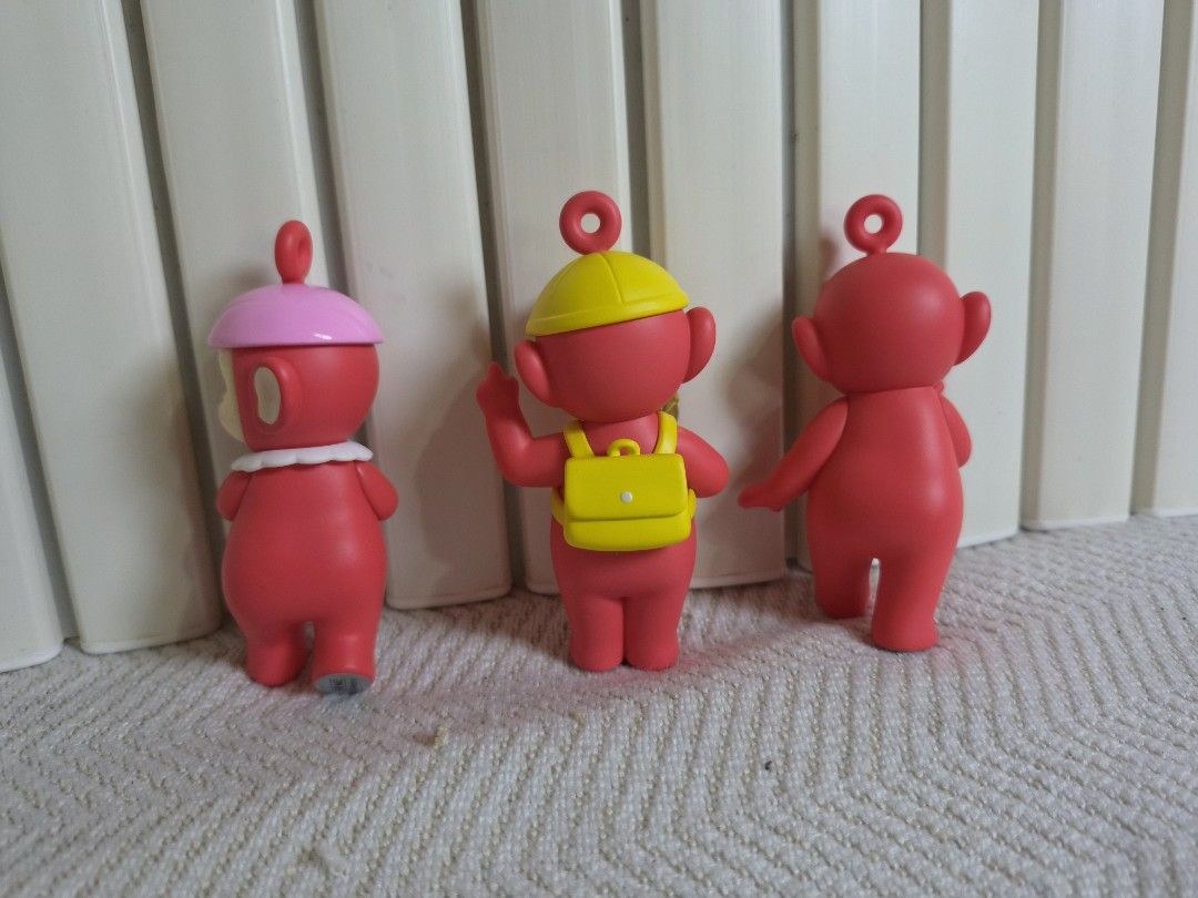 POP MART Teletubbies Figurine Set (Category: Designer & Blind Box Toys) located in Manila. Submitted by boldbear2001 (Listing ID 1470298372, Image 2). Description: Three POP MART Teletubbies figures in red. Includes Po variant with pink hat, Po variant with yellow hat and yellow backpack holding candy, and standard Po figure. Authentic stamping on the bottom of the feet. Clean paint details. Great additions for a collection or display setup. -Mis