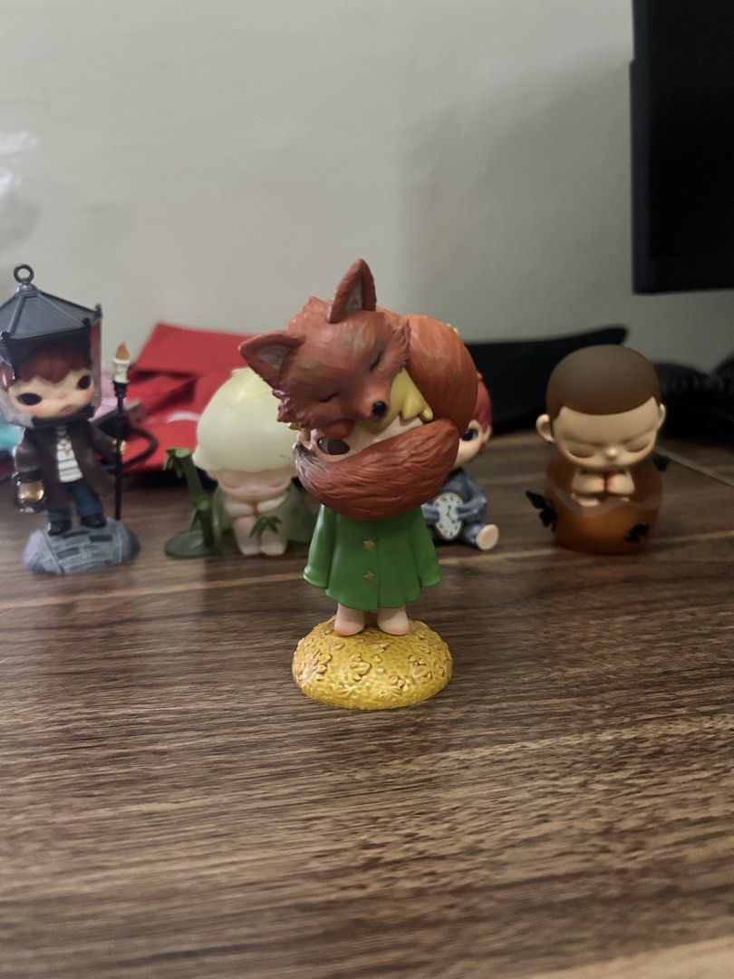 POPMART HIRONO FOX (Category: Figurines & Statues) located in Manila. Submitted by mihos.garage.sale (Listing ID 1470187265, Image 1). Description: - Authentic The Little Prince collectible vinyl figure - Design: Character in a green coat on a golden-yellow base, holding a reddish-brown fox - Condition: Carefully displayed on a shelf, excellent paintwork - Note: No box included - Perfect addition to any Little Prince collection!.
