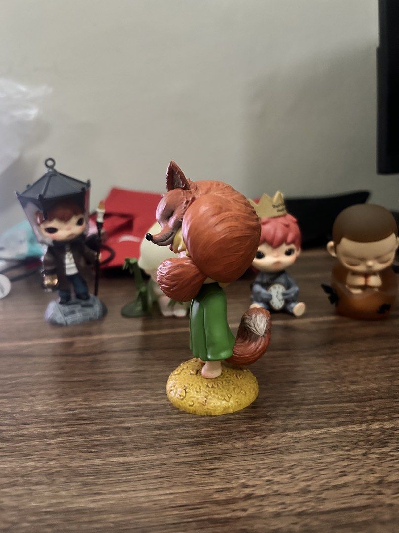POPMART HIRONO FOX (Category: Figurines & Statues) located in Manila. Submitted by mihos.garage.sale (Listing ID 1470187265, Image 2). Description: - Authentic The Little Prince collectible vinyl figure - Design: Character in a green coat on a golden-yellow base, holding a reddish-brown fox - Condition: Carefully displayed on a shelf, excellent paintwork - Note: No box included - Perfect addition to any Little Prince collection!.
