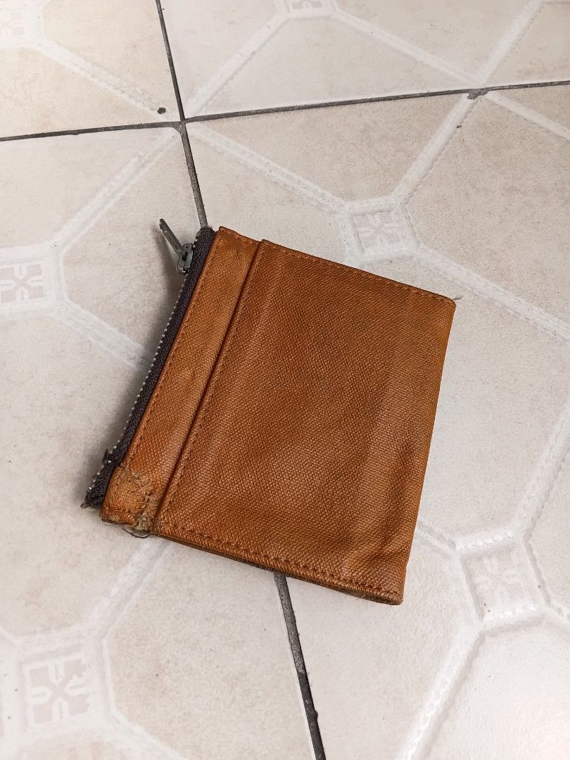 Porter International Bifold Wallet Brown Canvas (Category: Wallets & Card Holders) located in Manila. Submitted by grandflower-547aee (Listing ID 1470242650, Image 2). Description: - Brand: Porter International - Color/Material: Brown textured fabric - Closure: Secure snap button with exterior zip coin pocket on the back - Interior: Multiple card slots and slip compartments - Branding: Porter Made International woven label inside and front logo p