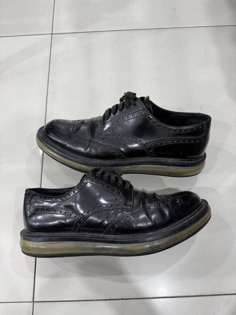 Prada Black Leather Brogues (Category: Dress Shoes) located in Bacolod City. Submitted by kitcarsonduff (Listing ID 1470190065, Image 2). Description: - Brand: Prada - Style: Classic black leather wingtip brogues with lace-up closure - Soles: Chunky rubber soles with traction tread pattern - Branding: Prada logo printed on the insole - Condition: Pre-loved with natural leather creasing and minor sole wear - Perfect for smart-casual wear, work, or