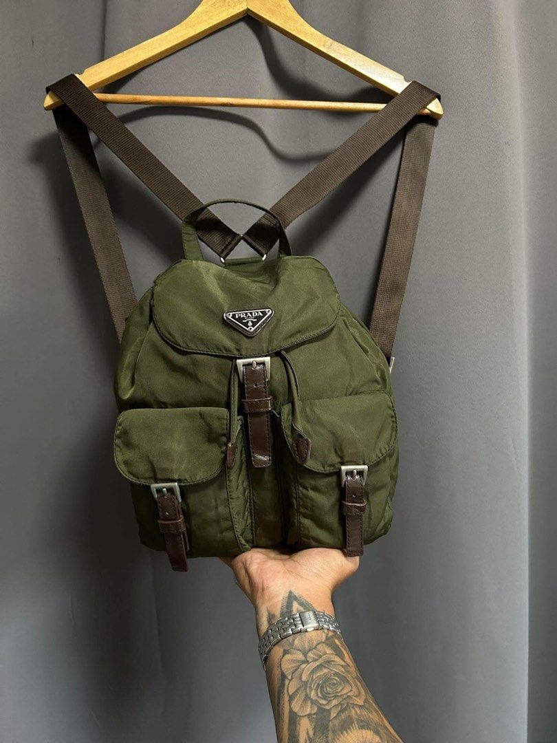 Prada nylon backpack in army green (Category: Backpacks) located in Bauang. Submitted by Fuzakenn (Listing ID 1470345350, Image 1). Description: - Authentic Prada backpack in army green nylon - Durable brown leather straps and silver-tone hardware - Secure drawstring and top flap closure with front pockets - Signature Prada jacquard fabric interior lining - Includes internal zip pocket and serial tag - Classic design, ideal for daily wear or trav