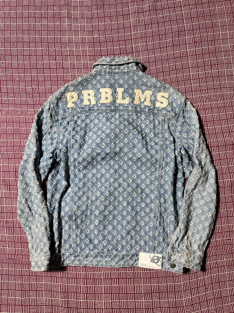 PRBLMS Distressed Light Wash Denim Jacket Size M (Category: Coats, Jackets and Outerwear) located in Manila. Submitted by wardrobeph.com (Listing ID 1470318670, Image 2). Description: - Brand: PRBLMS - Size: M - Wash: Light wash denim - Details: Heavy distressing with a raw hem finish - Back Design: Bold white chenille patch lettering spelling PRBLMS across the shoulders - Hardware: Metal button closures on front and chest pockets - Branding: Red