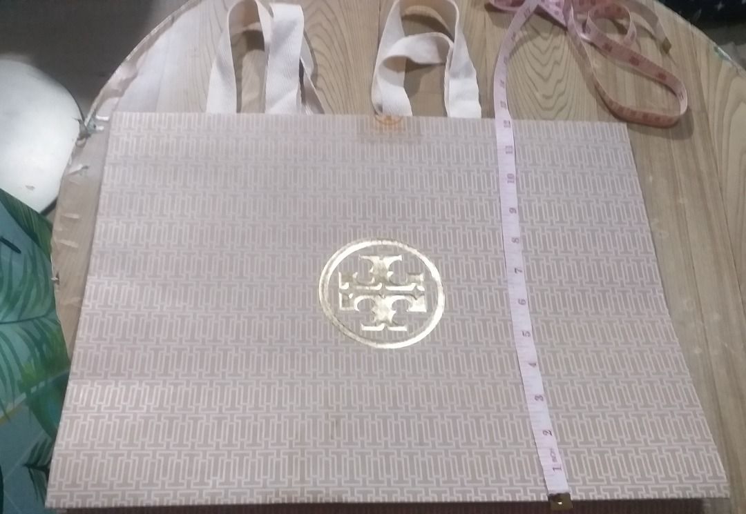 preloved Tory Burch Designer Paper Bag (Category: Tote Bags) located in Pasig City. Submitted by jocel8432 (Listing ID 1470207176, Image 2). Description: - 100% Authentic Tory Burch paper shopping bag - Features the iconic T Monogram pattern in a chic pink and beige colorway - Designed with durable cream fabric ribbon handles - Ideal for gifting, organizing, or adding to your designer packaging collection.
