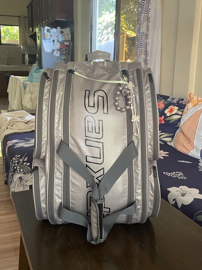 Pukues Sports Bag Backpack Gray (Category: Backpacks) located in Sindangan. Submitted by squishyyyxoxo (Listing ID 1470150239, Image 1). Description: - Brand: Pukues - Color: Gray with bold black vertical branding - Compartments: Multiple compartments for easy organization - Straps: Adjustable gray shoulder straps on the front - Design: Structured rectangular shape with reinforced vertical piping - Extra: Comes with a decorative beaded bracelet a