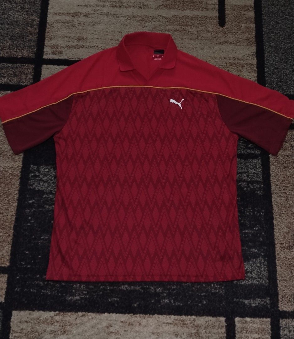 Puma Red Diamond Pattern Polo Shirt (Category: Tshirts & Polo Shirts ) located in Manila. Submitted by ianmontede19006 (Listing ID 1470174423, Image 1). Description: - 100% Authentic Puma merchandise - Size: Medium (M) - Color: Red with white Puma logo on the chest - Design: Geometric diamond pattern across the lower front section - Features: Classic collar neckline and short sleeves - Origin: Made in Vietnam.