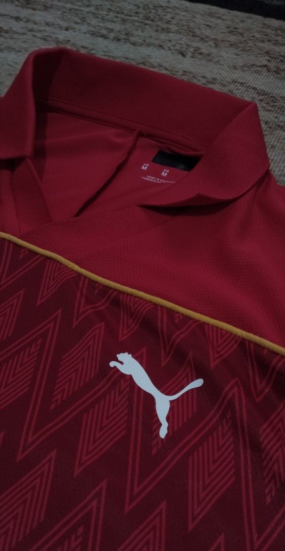 Puma Red Diamond Pattern Polo Shirt (Category: Tshirts & Polo Shirts ) located in Manila. Submitted by ianmontede19006 (Listing ID 1470174423, Image 2). Description: - 100% Authentic Puma merchandise - Size: Medium (M) - Color: Red with white Puma logo on the chest - Design: Geometric diamond pattern across the lower front section - Features: Classic collar neckline and short sleeves - Origin: Made in Vietnam.