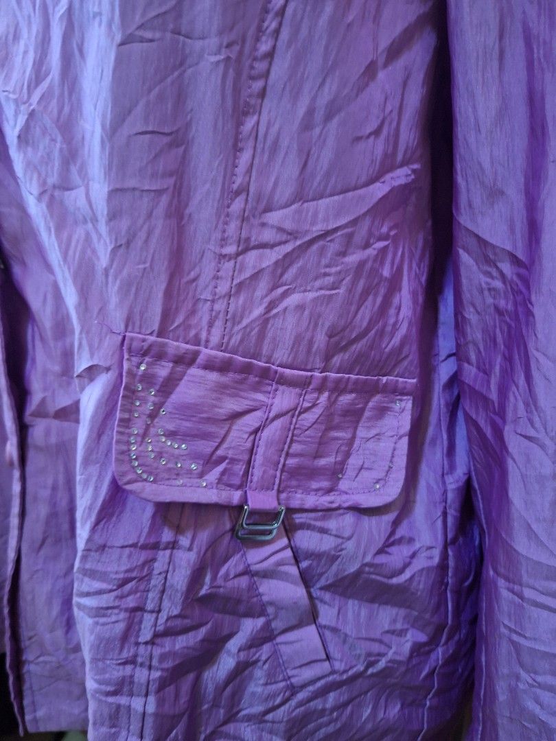 2000s Style Purple button-down jacket with pocket detailing (Category: Coats, Jackets and Outerwear) located in Balamban. Submitted by ubethan (Listing ID 1470214154, Image 3). Description: - Color: Purple - Material: Lightweight crinkled fabric - Closure: Button-front with matching round buttons - Pockets: Two chest pockets with buckled straps and rhinestone details - Features: Long sleeves, collar, and a matching back waist strap.