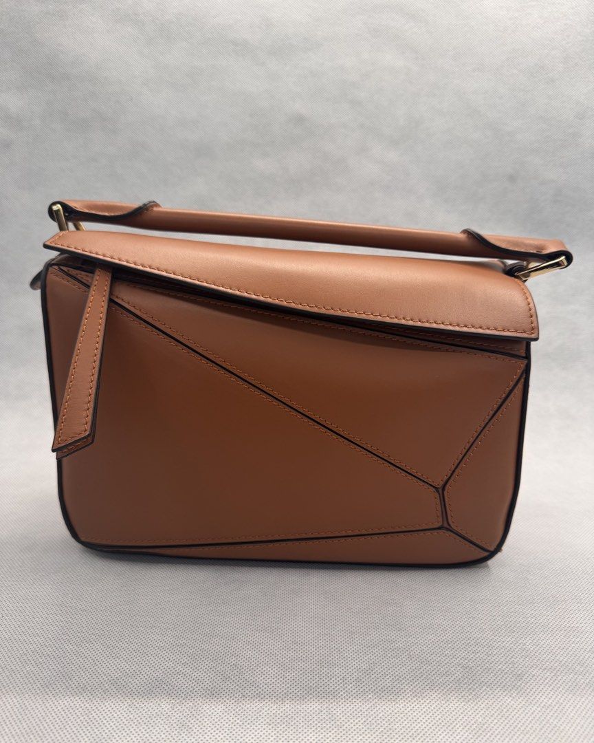Puzzle Bag (Tan) - Italian Leather (Category: Shoulder Bags) located in Las Pinas. Submitted by uynice.ph (Listing ID 1470213315, Image 1). Description: 🤎 ITALIAN LEATHER PUZZLE-STYLE BAG | TAN ✨ Get that luxury look for less! Love the iconic geometric silhouette? This designer-inspired bag is chic, versatile, and effortlessly stylish! A structured Italian leather bag featuring geometric panel detailing, gold-tone hardware, and a timeless tan fi