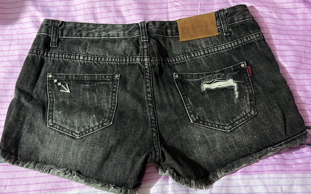 QSUFFER Black Distressed Denim Shorts (Category: Shorts) located in Manila. Submitted by prelovedbynors_ (Listing ID 1470231564, Image 2). Description: - Brand: QSUFFER - Color/Wash: Black with washed finish and factory distressing - Details: Frayed raw hems and unique studded arrow hardware on front and back pockets - Branding: Brown leather patch on the back waistband - Closure: Classic button Size: 32 inches.