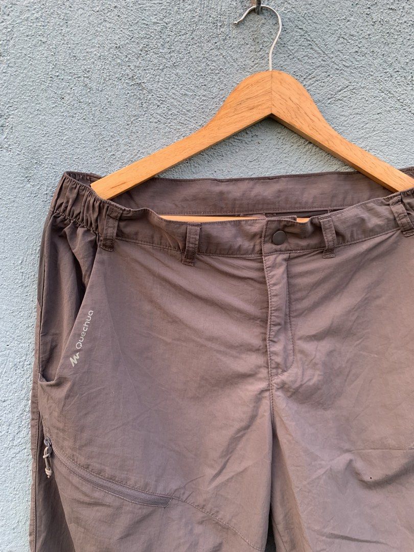 Quechua Hiking Trousers Brown (Category: Trousers) located in Manila. Submitted by rommelx-07 (Listing ID 1470255533, Image 3). Description: Quechua outdoor trekking trousers in dark brown. Elastic waistband with belt loops, zip pocket on the right thigh, and reinforced panel details. Note there is a small hole near the front thigh area and some wear on the inner brand tag. Lightweight synthetic fabric..